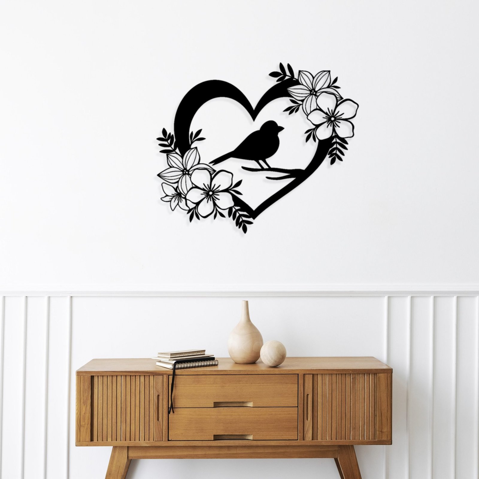 Wooden sideboard table with books and a vase